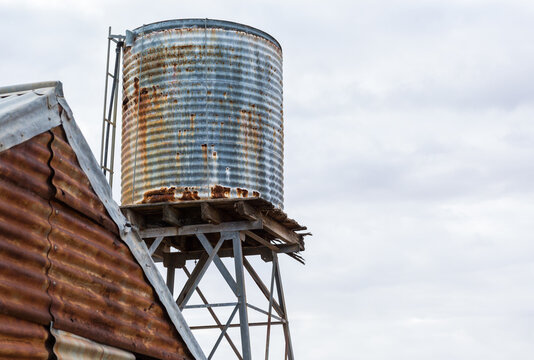 Rusty corrugated iron tank and shed