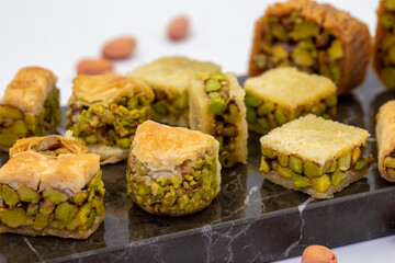 Varieties of pistachio baklava. Variety of baklava isolated on white background. Traditional Turkish cuisine delicacies. Desserts with pistachio syrup in the middle. close up