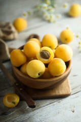 Naklejka na ściany i meble Fresh ripe apricots in a wooden bowl