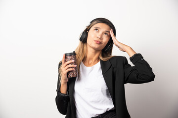 Businesswoman with cup and headphones