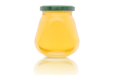 A jar of fresh yellow honey on a white background