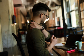 Young businessman having backache.