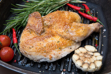char-grilled chicken, with rosemary, tomato, hot pepper, garlic, green in pan grill