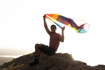 Happy man with a pride flag. LGBT community.