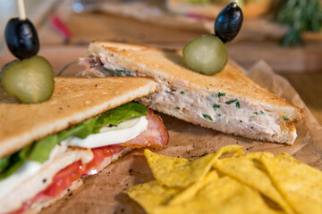 Chicken and bacon sandwich, with tomatoes, pickles, olives