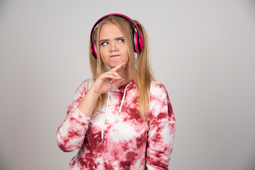 Portrait of young woman in pink outfit thinking