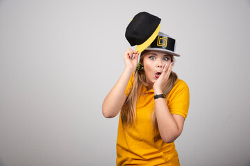 A trendy beautiful long haired model posing in a cap