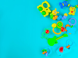 Children's toys rattles on a light blue background. Top view, flat position. The concept of child development. Place for text.