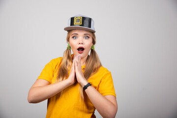 Portrait of cute woman posing with a gray stylish cap