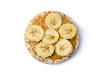 Isolated rice cake with peanut butter and banana slice on white background
