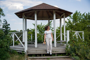 woman walking in a white dress near alcove