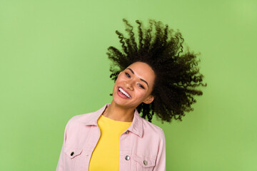Photo of cheerful good mood female spin head flying hair fooling around enjoy summer isolated on green color background