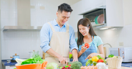 couple are cutting vegetable