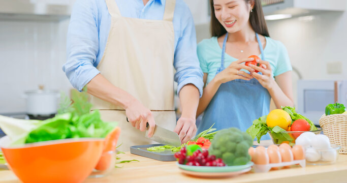 couple are cutting vegetable