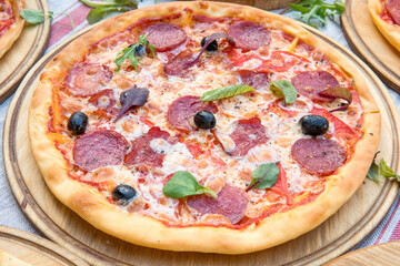 Hot big pepperoni pizza tasty pizza composition with melting cheese bacon tomatoes ham paprika