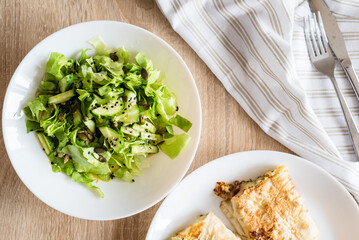 Fresh vegetable salad with cucumber and lettuce, chia seeds, black sesame seeds and salmon lavash