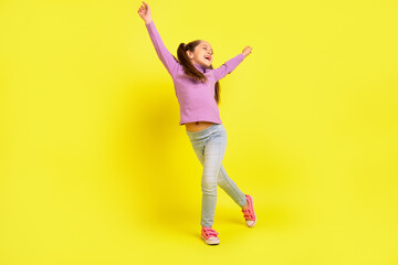 Full length photo of positive cheerful school kid dancing energetic raise hands up isolated shine color background