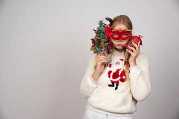 Woman in masquerade mask holding gift and pinetree