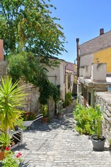 A narrow street between the old houses of Pietrelcina a village in the province of Benevento, Italy.	