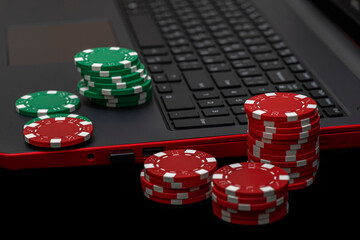 Gambling online casino Internet betting concept. Jackpot, casino chips. computer keyboard, laptop with poker chips, dice. Casino tokens, gaming chips, checks, or cheques