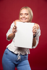 Blonde artist showing her artwork with joyful confidence