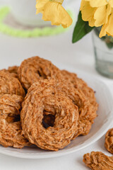 Vegan apple cookies close up with tea cup on a white plate on a table. Healthy eating. Gluten free.