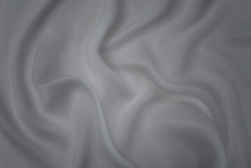 Silk or cotton fabric tissue. Dark gray or black color. Texture, background, pattern.