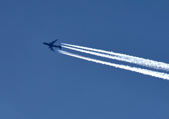 Plane with traces high in the skies