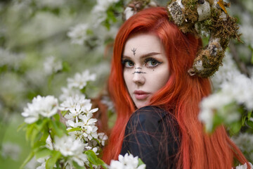 Close-up portrait of a red-haired witch with moss-covered horns