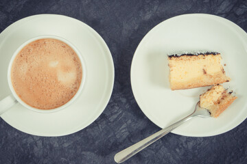 Fresh baked cheesecake and cup of coffee with milk. Delicious dessert