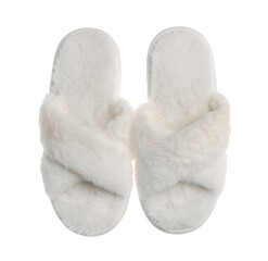 Pair of soft fluffy slippers on white background, top view