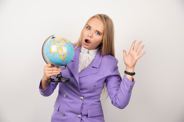 Woman teacher with globe posing on white background