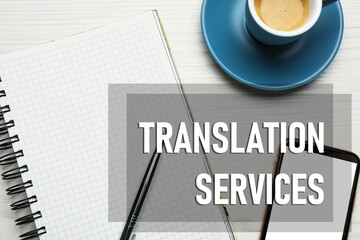 Translation services. Flat lay composition with notebook on white wooden table