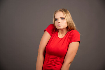 Portrait of young woman posing over dark background