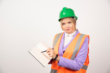 Female builder in helmet with tablet on white background