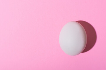 Creative happy easter, food card, egg white shell on a pink background.