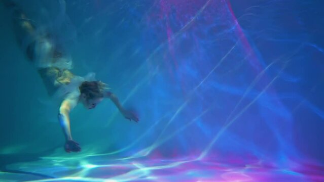 Slow Motion Woman in a sequin dress underwater