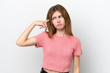 Young English woman isolated on white background making the gesture of madness putting finger on...
