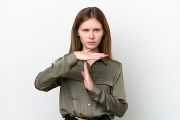 Young English woman isolated on white background making time out gesture