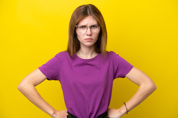 Young English woman isolated on yellow background angry