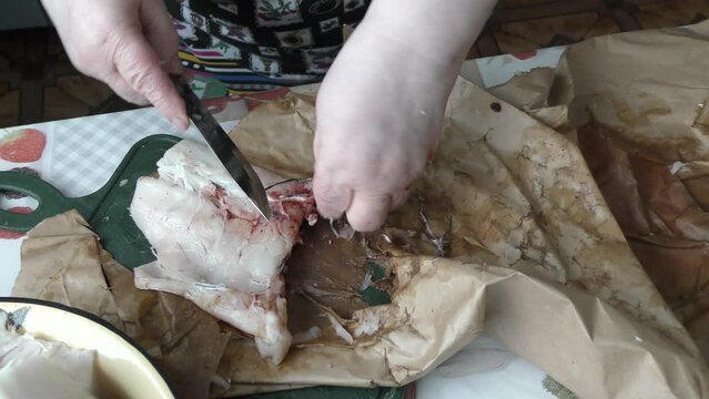 the cook cuts into pieces sea fish cod