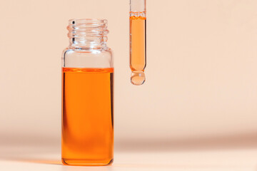 Pipette with a glass bottle on a light background.