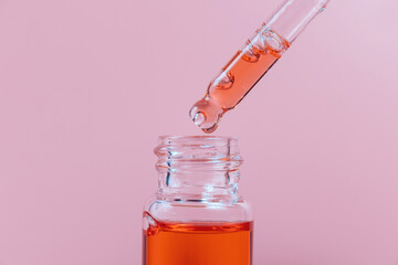 Pipette with a glass bottle on a light background.