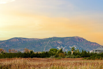 Mountains at Massamagrell in Valencia, Spain. Autumn landscape with mountain near Horta Nord in the Valencian Community. Valley against dramatic sky and clouds. Hike to Rock sunset. Rocky scenery.