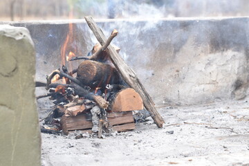 bonfire with logs to make an argentine asado (barbecue)