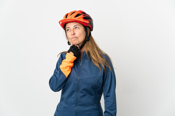 Middle age cyclist woman isolated on white background having doubts