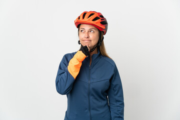 Middle age cyclist woman isolated on white background and looking up
