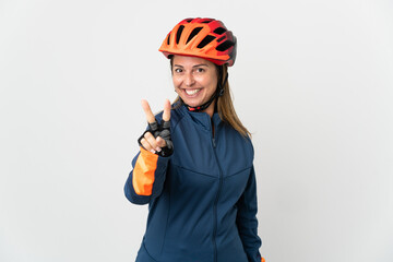 Middle age cyclist woman isolated on white background smiling and showing victory sign