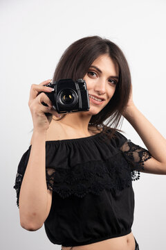 Brunette woman taking pictures with camera