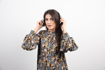 Brunette woman listening to music with serious expression